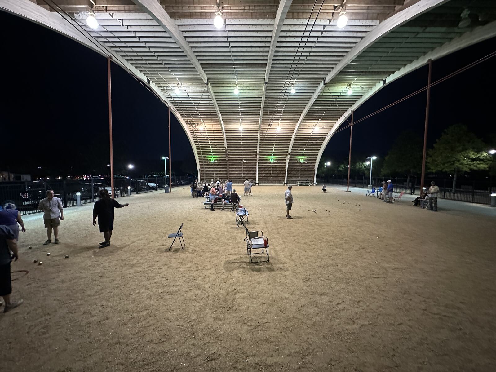 The Hangar at night, lit from above, with people playing on the floor.